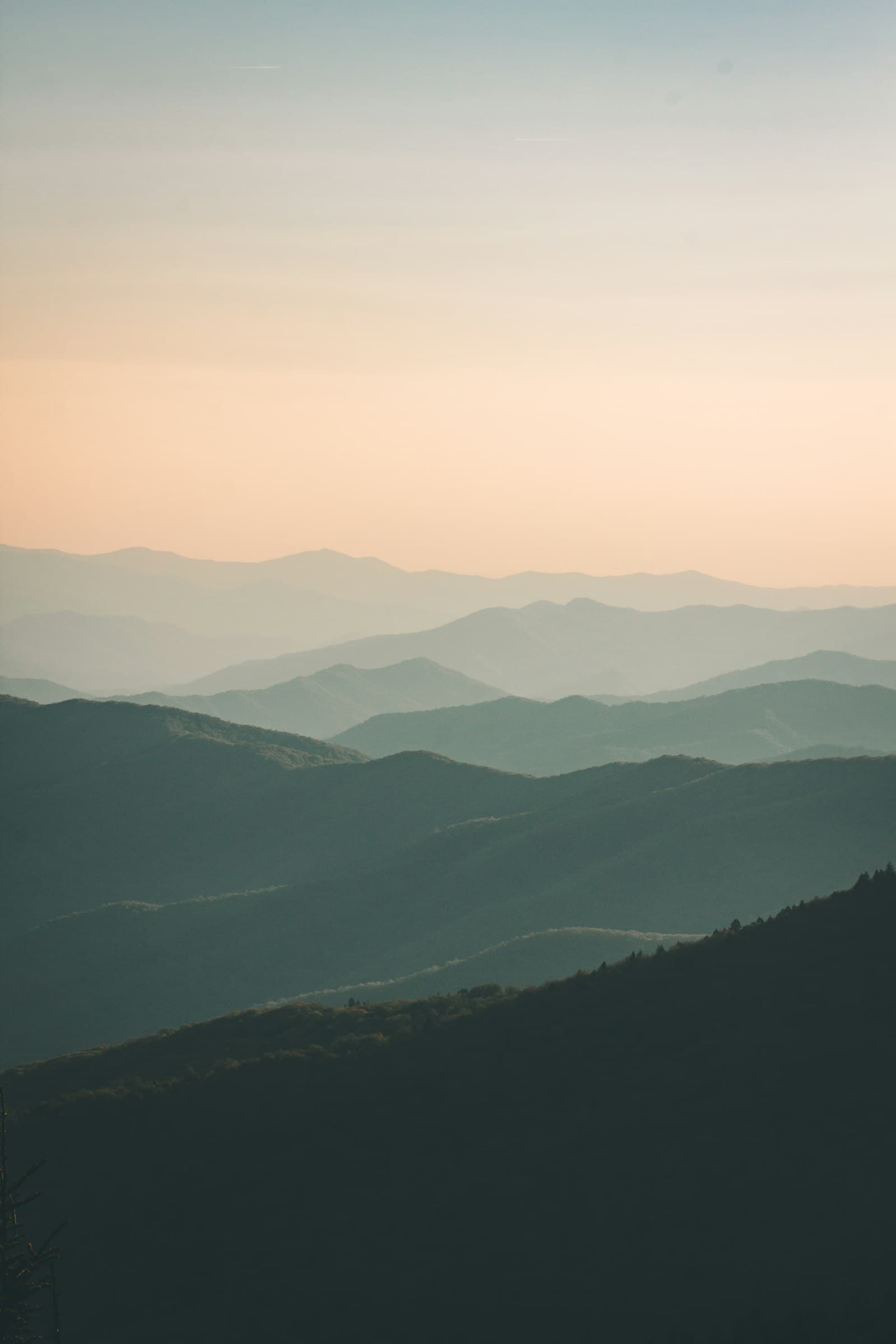Layered blue mountain ridges fading into morning haze