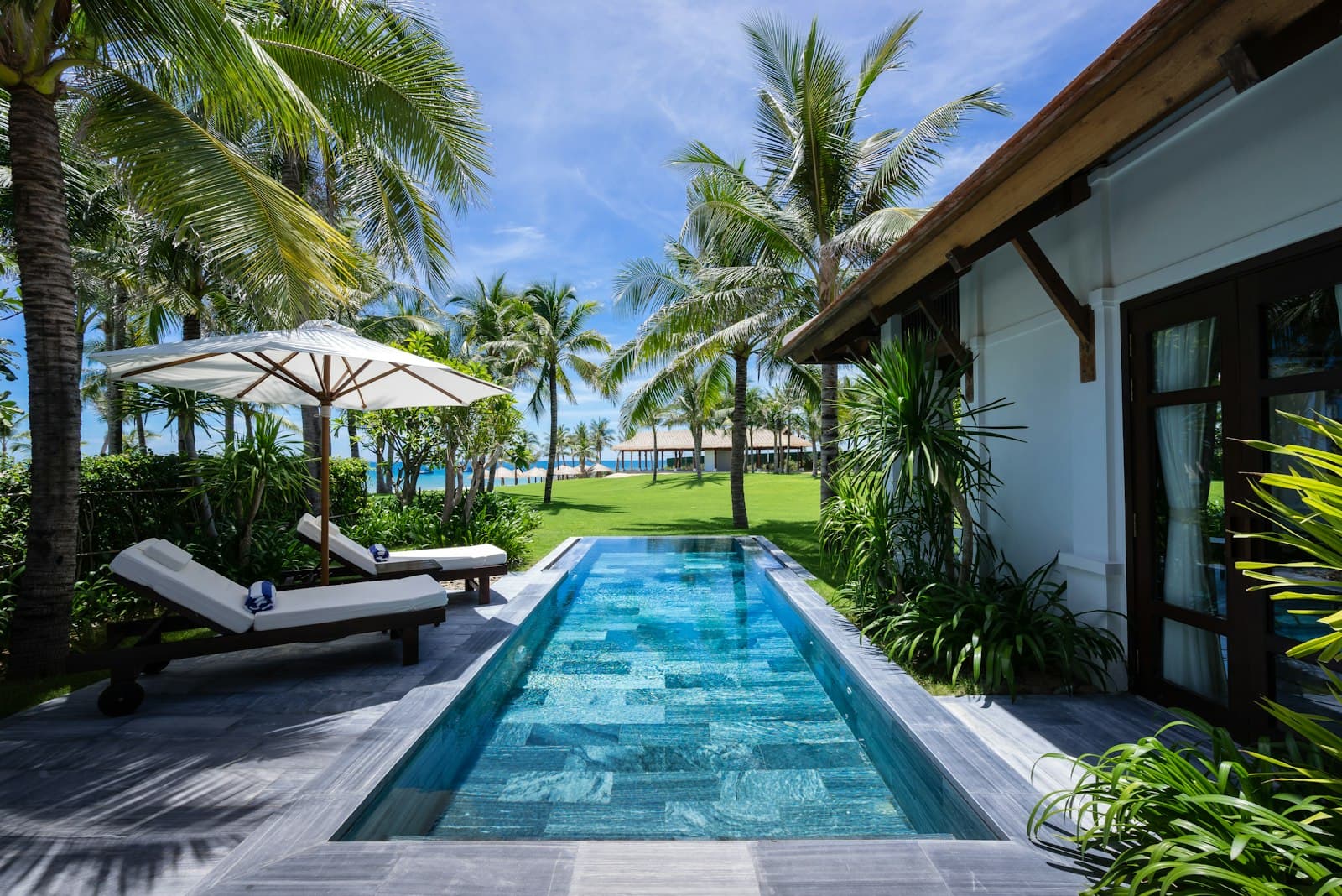 A long reflecting pool running the length of a modern garden villa