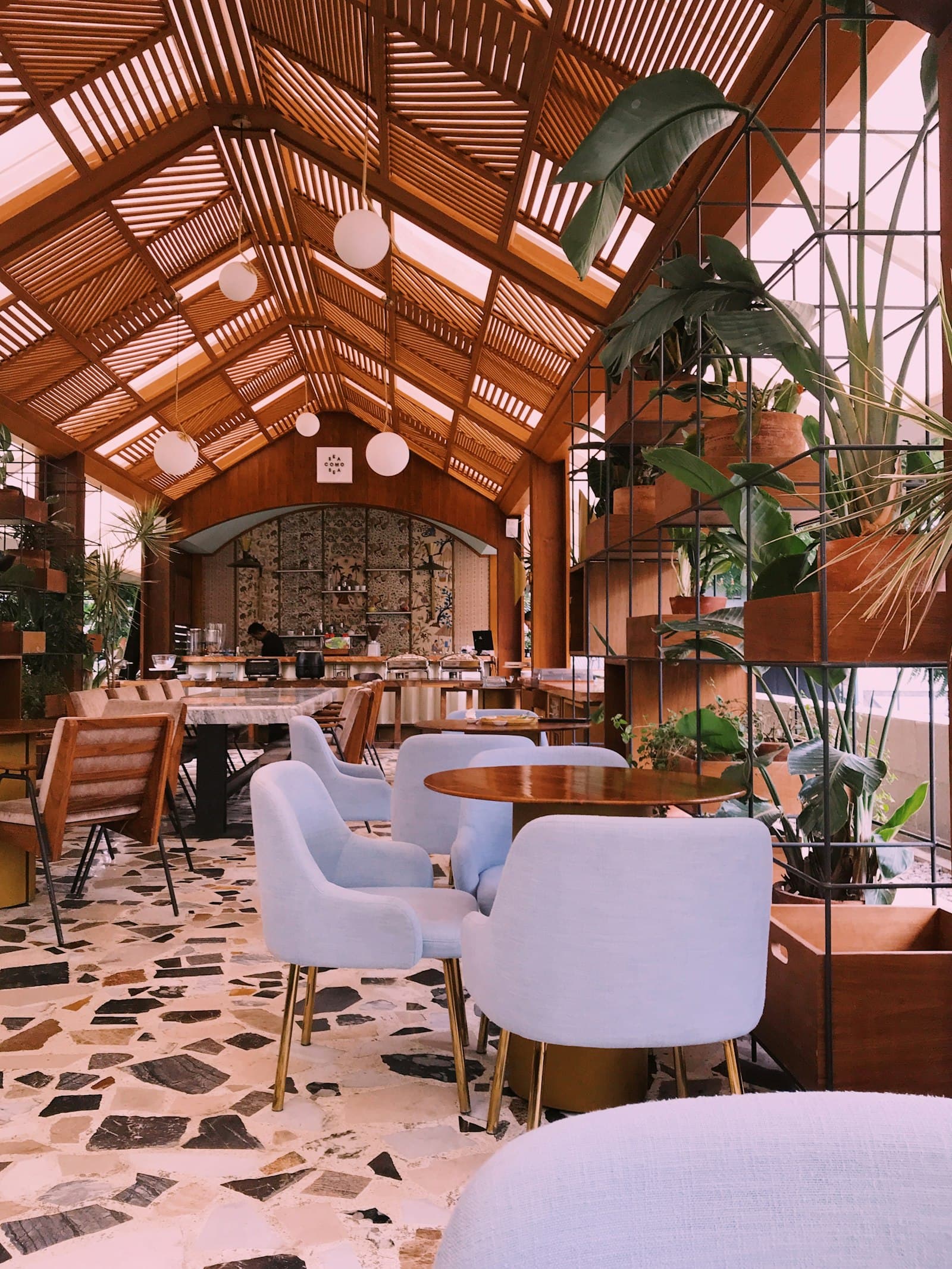 A timber lodge dining room with vaulted ceilings and garden views